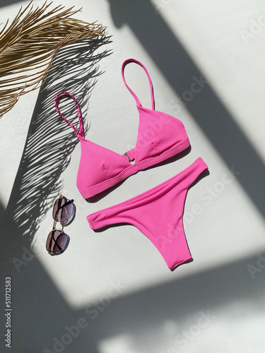 Quadro su tela Pink swimsuit and sunglasses. Summer clothes Still life