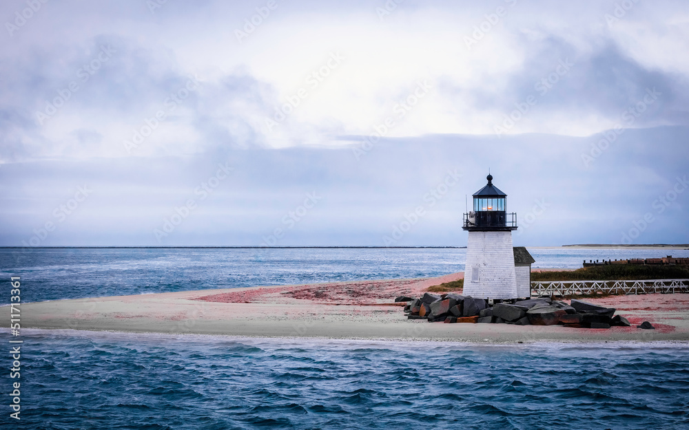 Stormy seascape in the rain in the Atlantic Ocean. Brant Point Light Lighthouse on the Tip of Sand Bar on Nantucket Island