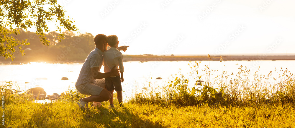 Leinwandbild Motiv - Maksim Shmeljov : Father and his little son. Happy loving family walking outdoor in the light of sunset.