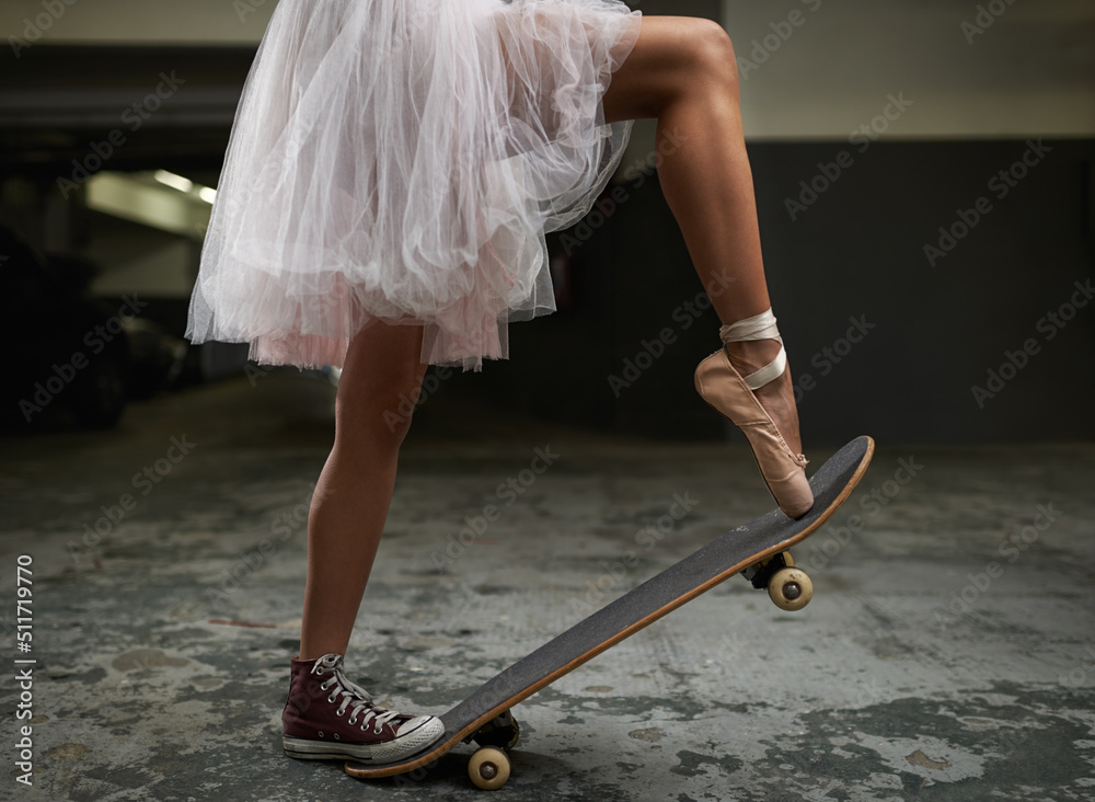 have many talents. A cropped image of a woman on a skateboard wearing sneakers and ballet slipper. Stock-foto | Adobe Stock