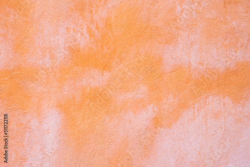 Empty orange concrete stain wall with weathered condition. ideal for background or wallpaper for vintage and grunge concept.