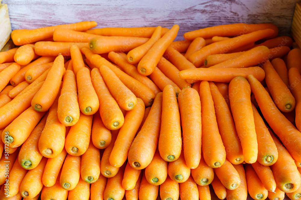 Many carrots placed raw in a container box for sale. Many carrots placed raw in a container box for sale.