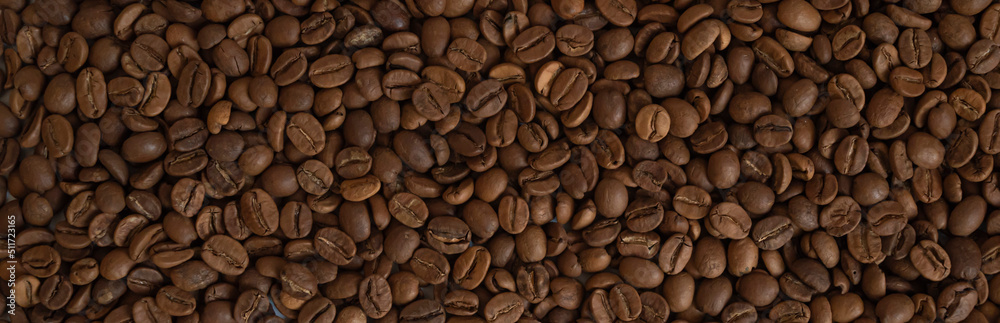 Roasted dry fresh coffee beans background.