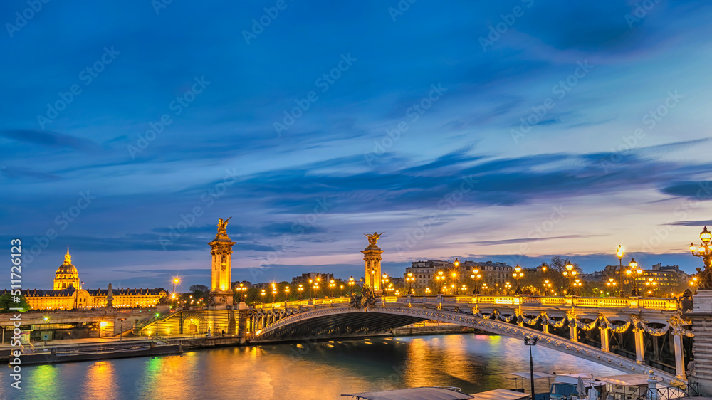 Paris France night city skyline at Seine River with Pont Alexandre III bridge