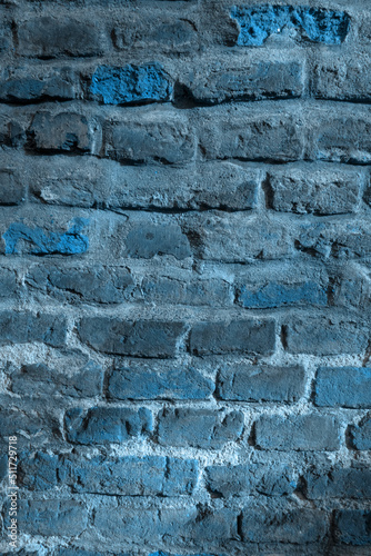 Demaged Rough Brick Wall Surface. Old Brick Wall in the Blue Moonlight. Cool Background. Medieval Wall. photo