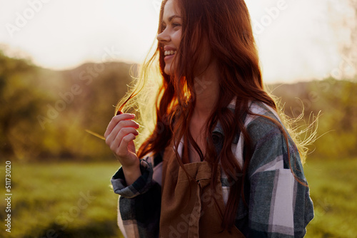 Woman smiling in the background of sunset sunlight in nature