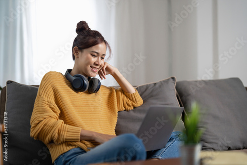 Young asian woman having conversation chatting while using laptop at house. Work at home, Video conference, Online meeting video call, Virtual meetings, Remote learning and E-learning.