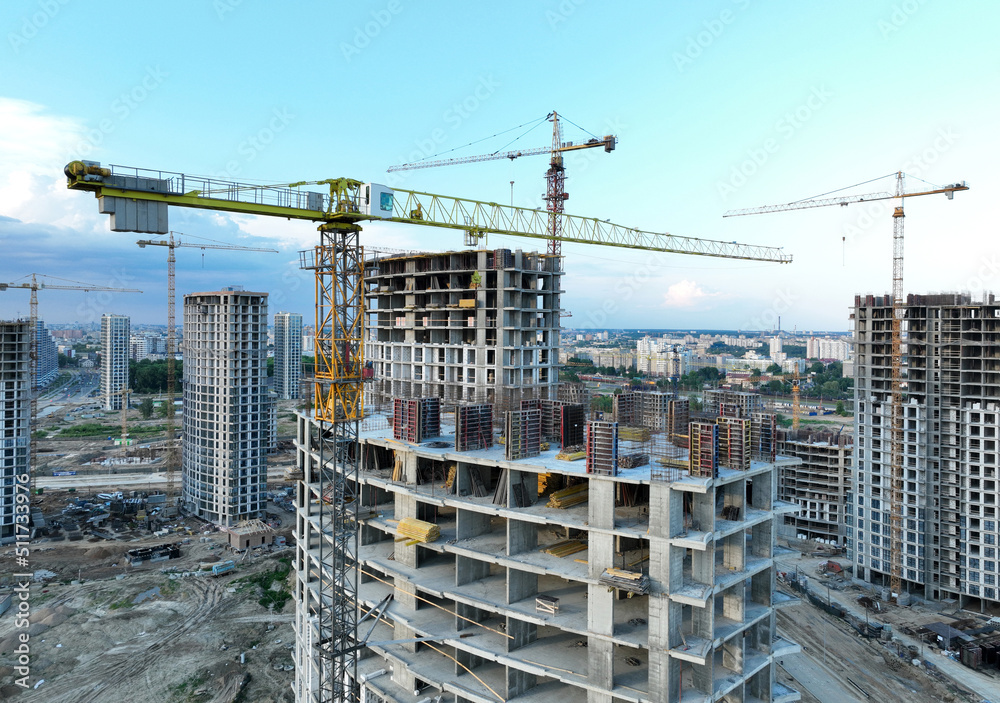 Сonstruction site with tower cranes on building construction. Builder on formworks. Cranes on pouring concrete in formwork. Tower cranes on construction in built environment. Buildings renovation.. Сonstruction site with tower cranes on building construction. Builder on formworks. Cranes on pouring concrete in formwork. Tower cranes on construction in built environment. Buildings renovation..