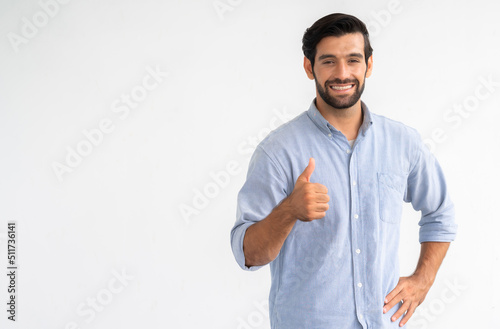 Nice smile friendly Cauasian man in blue shirt giving thumbs up on white background photo
