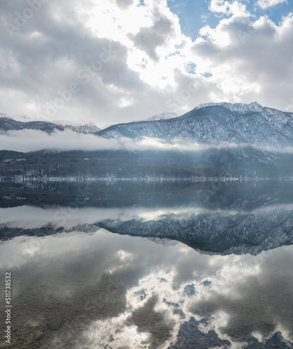 Beautiful winter reflections at Lake Bohinj in Slovenia. National park in winter. 