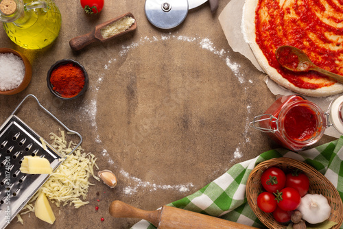 Pizza ingredients on table. Bread recipe homemade at tabletop background