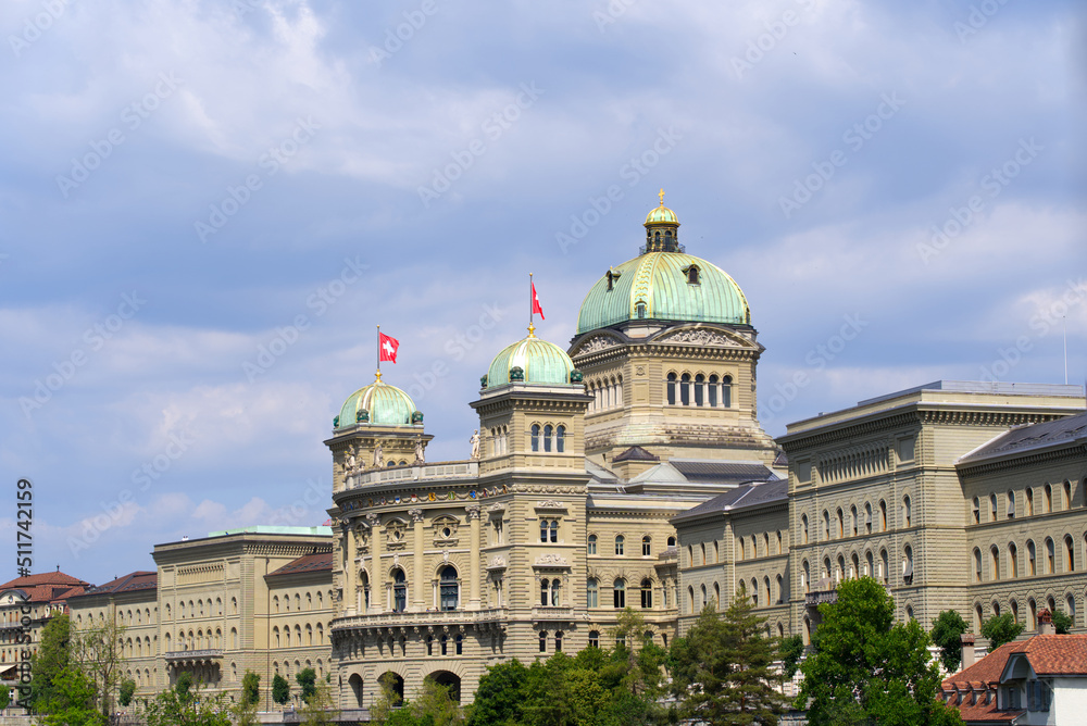 Federal Palace of Switzerland (German Bundeshaus), residence of national Swiss government and parliament, on a blue cloudy summer day. Photo taken June 16th, 2022, Bern, Switzerland.