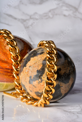 golden gold chain , to be used as necklace or bracelete in a composition with marble eggs