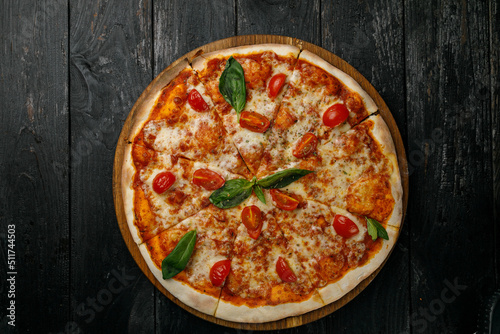 Italian cuisine. Pizza on a black table 
