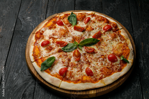 Italian cuisine. Pizza on a black table
