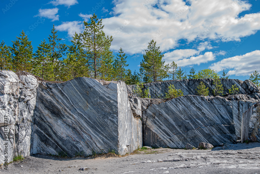 Fototapeta premium Geology rock formation. Extraction of marble. Geology rock formation. Extraction of marble. Geological formation of marble. The natural stone. Ancient Marble quarry, marble rocks in the wild.