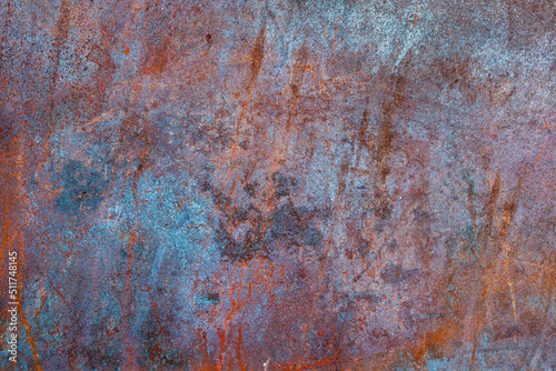 Rusted metal texture with orange and aquamarine spots. Rust surface background. Close up of rust on an old sheet of metal.