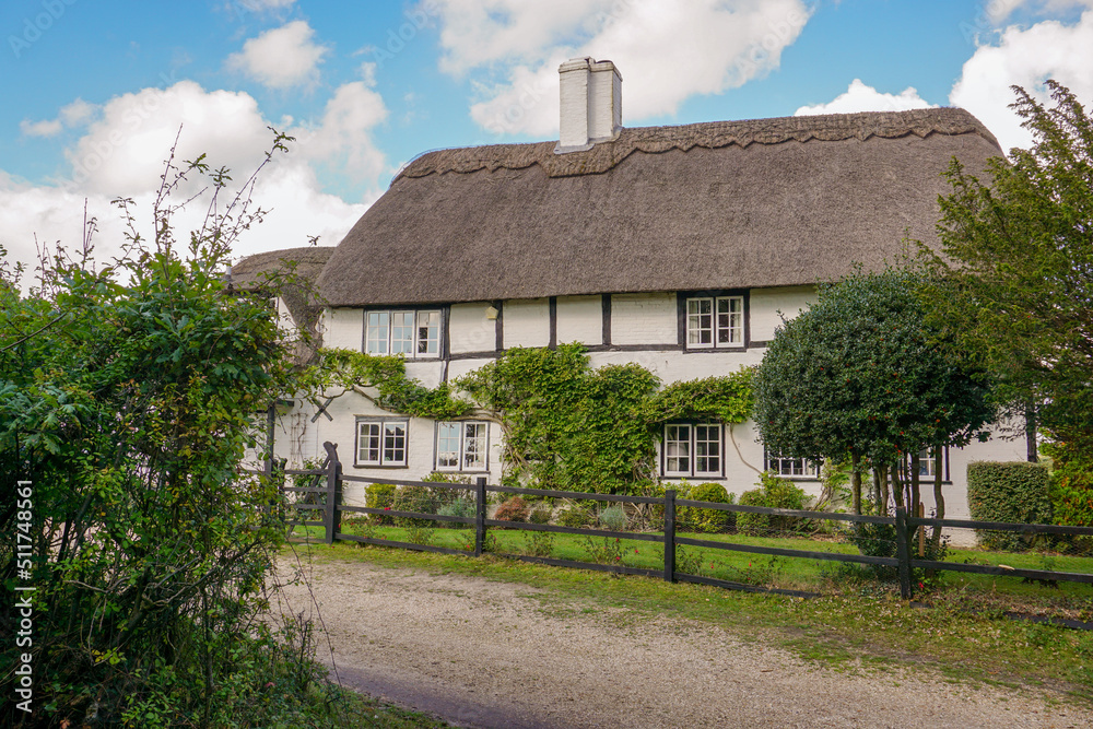 quaint English cottage. picturesque country house with traditional thatched roof. timber framed rural home