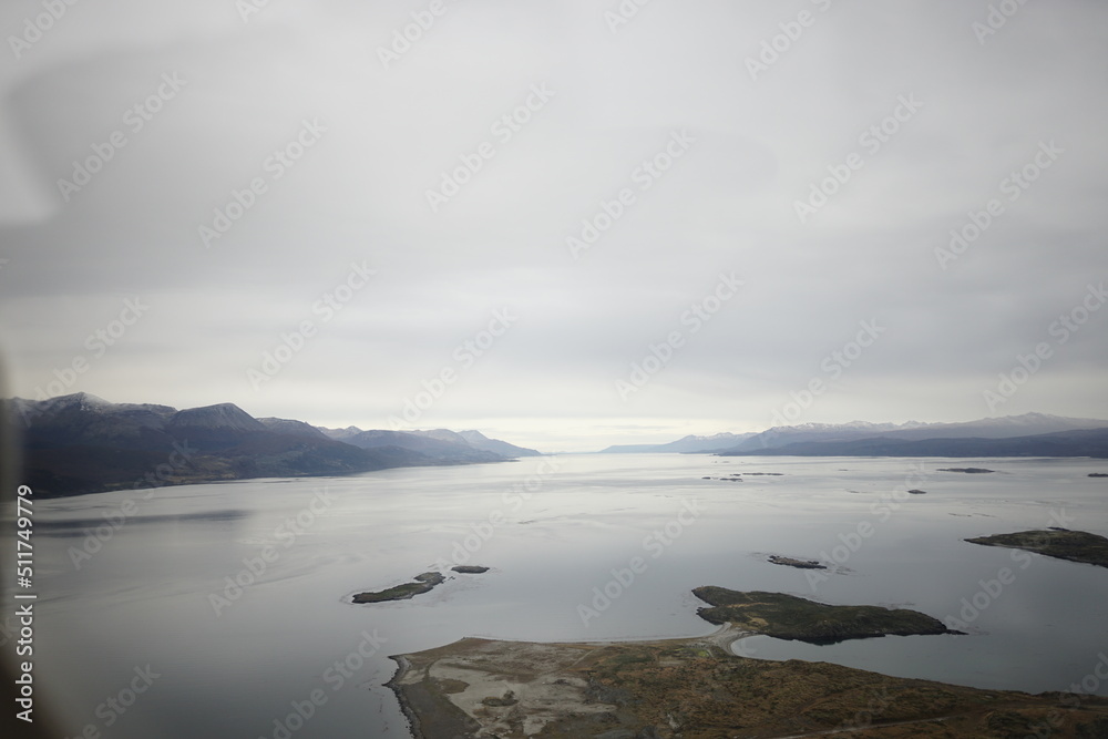 the photo captures the moment of takeoff and flight by plane over Ushuaia — a city and port in southern Argentina. the photo captures the moment of takeoff and flight by plane over Ushuaia — a city and port in southern Argentina.
