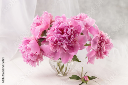 Bouquet of pink peonies in a vase on a wooden table. Gift Valentine's Day