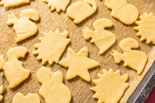 baking cookies with cut shapes.