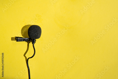 buttonhole microphone on a yellow background photo