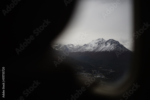 the photo captures the moment of takeoff and flight by plane over Ushuaia — a city and port in southern Argentina.
