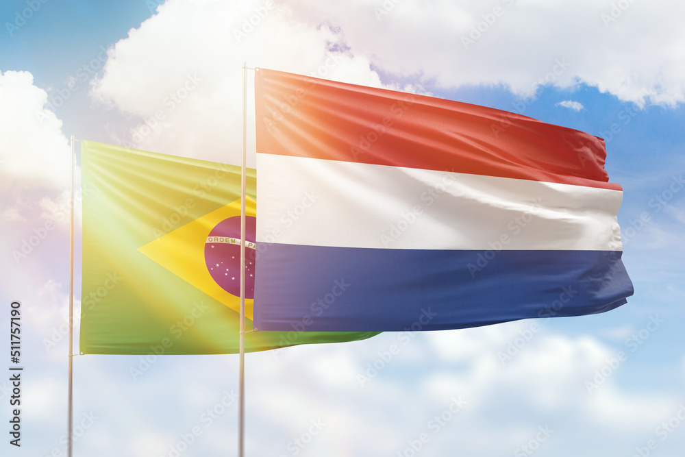 Sunny blue sky and flags of netherlands and brazil Sunny blue sky and flags of netherlands and brazil