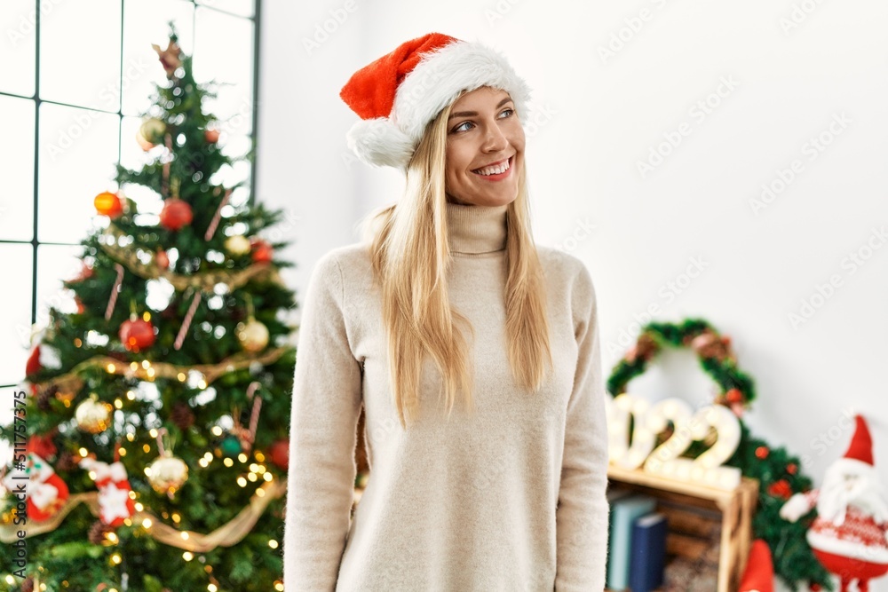 Young blonde woman smiling confident standing by christmas tree at home Young blonde woman smiling confident standing by christmas tree at home