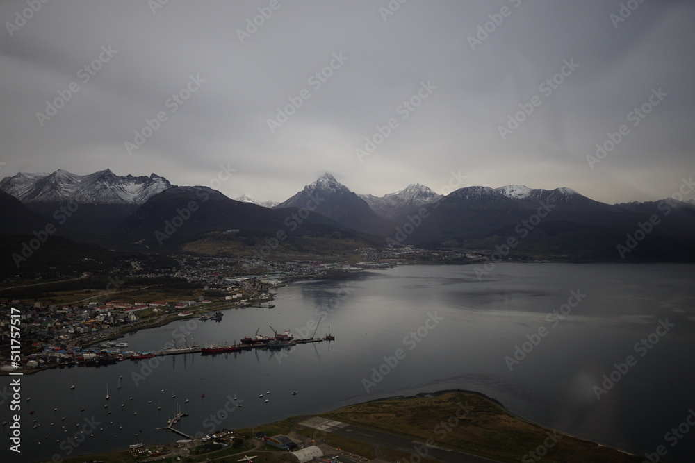 the photo captures the moment of takeoff and flight by plane over Ushuaia — a city and port in southern Argentina.
