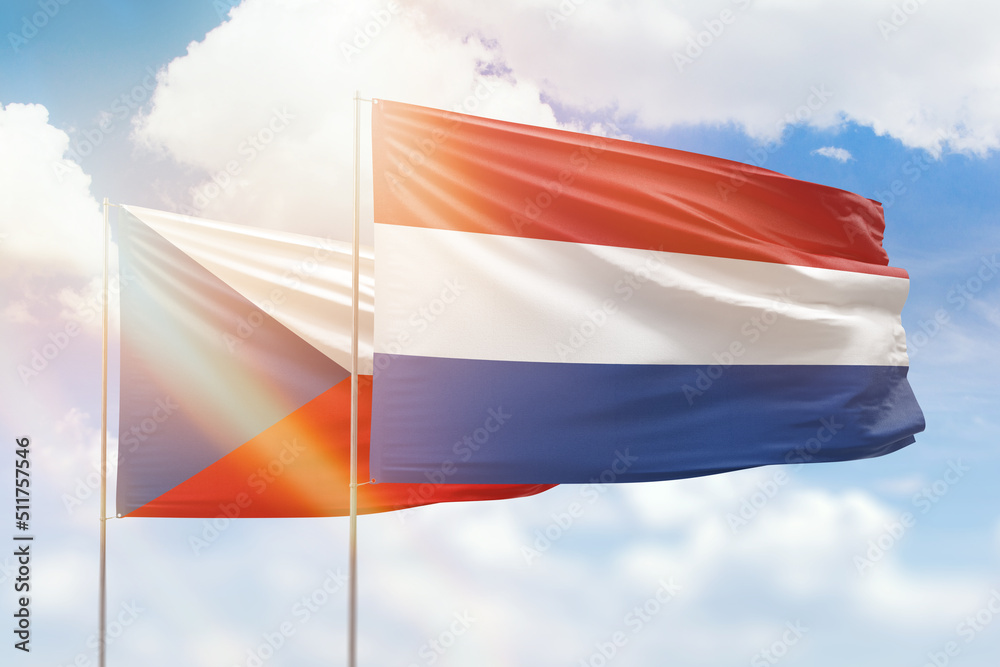 Sunny blue sky and flags of netherlands and czechia Sunny blue sky and flags of netherlands and czechia