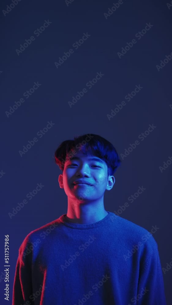 Perfect choice. Neon light guy. Special offer. Red blue color Asian man approving invisible product with thumbs up isolated on dark vertical advertising copy space background set of 4. Perfect choice. Neon light guy. Special offer. Red blue color Asian man approving invisible product with thumbs up isolated on dark vertical advertising copy space background set of 4.