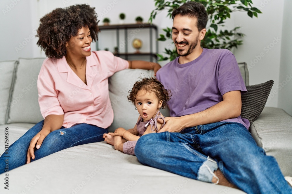 Couple and daughter smiling confident sitting on sofa at home Couple and daughter smiling confident sitting on sofa at home