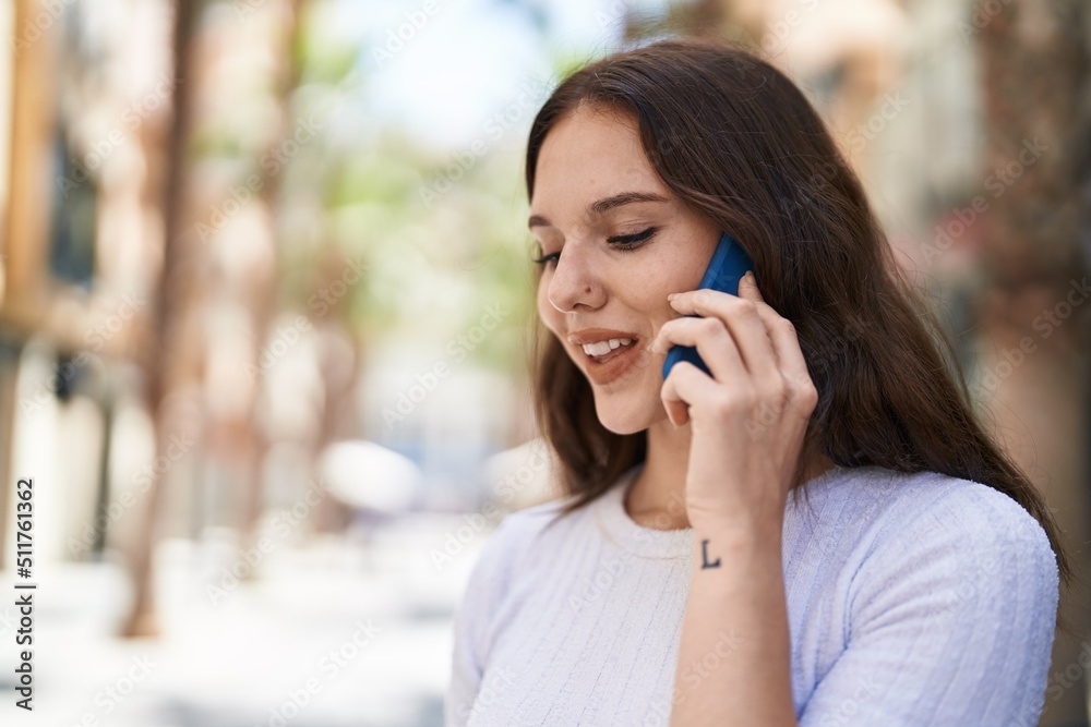 Young woman smiling confident talking on the smartphone at street Young woman smiling confident talking on the smartphone at street