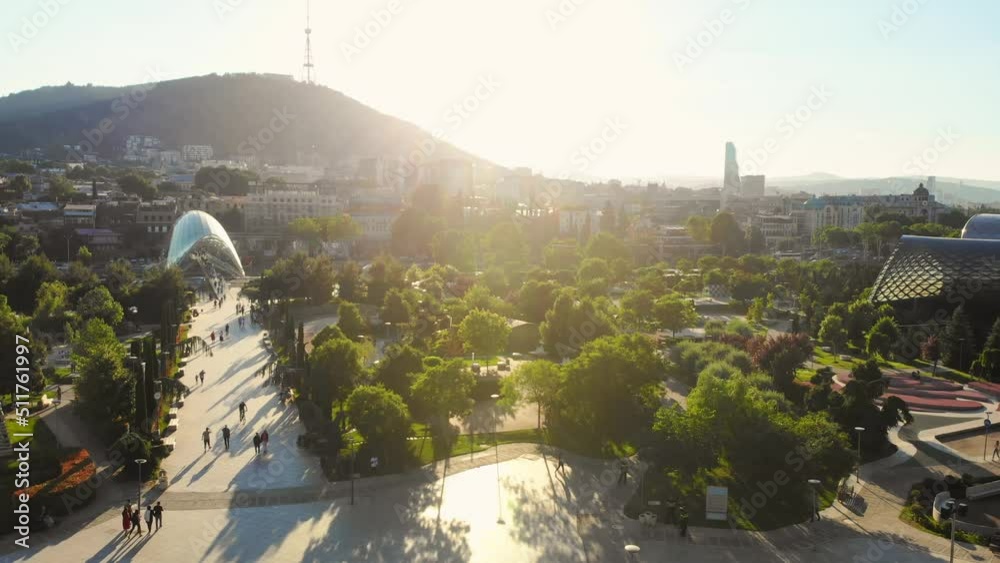 Tbilisi, Georgia, 4th october, 2021: Modern Rike park and peace bridge view with tourist walking. Tbilisi city center panorama outdoors