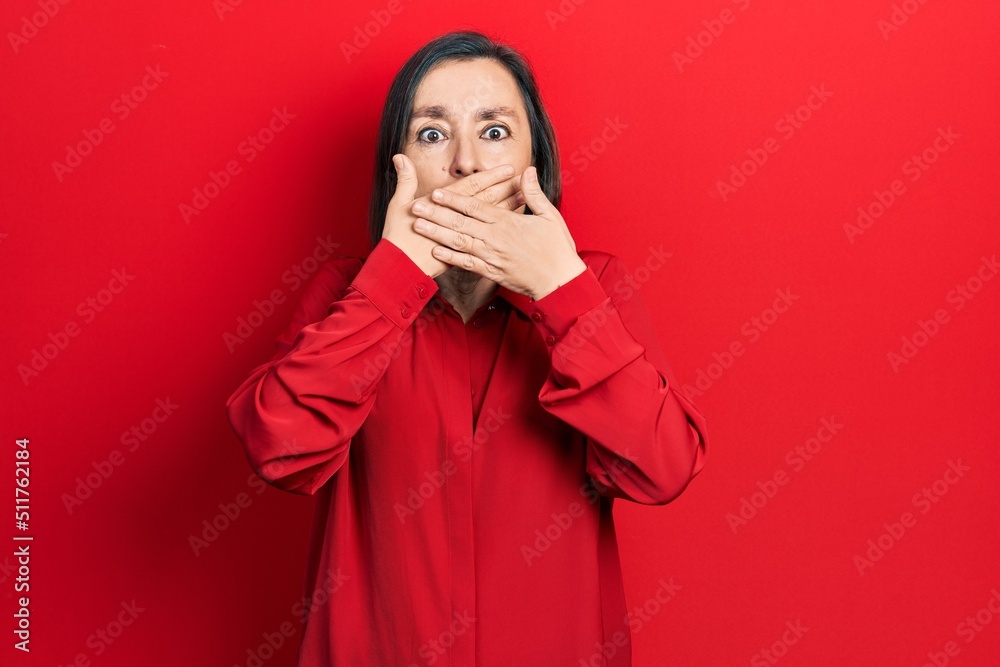 Middle age hispanic woman wearing casual clothes shocked covering mouth with hands for mistake. secret concept. Middle age hispanic woman wearing casual clothes shocked covering mouth with hands for mistake. secret concept.