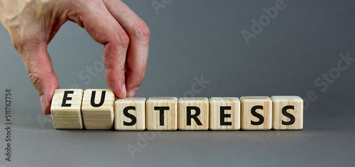 Eustress or stress symbol. Psychologist turns cubes and changes the concept word Eustress to Stress. Beautiful grey table grey background, copy space. Psychlogical stress or eustress concept. photo