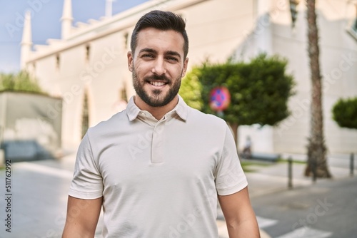 Young hispanic man smiling confident walking at street