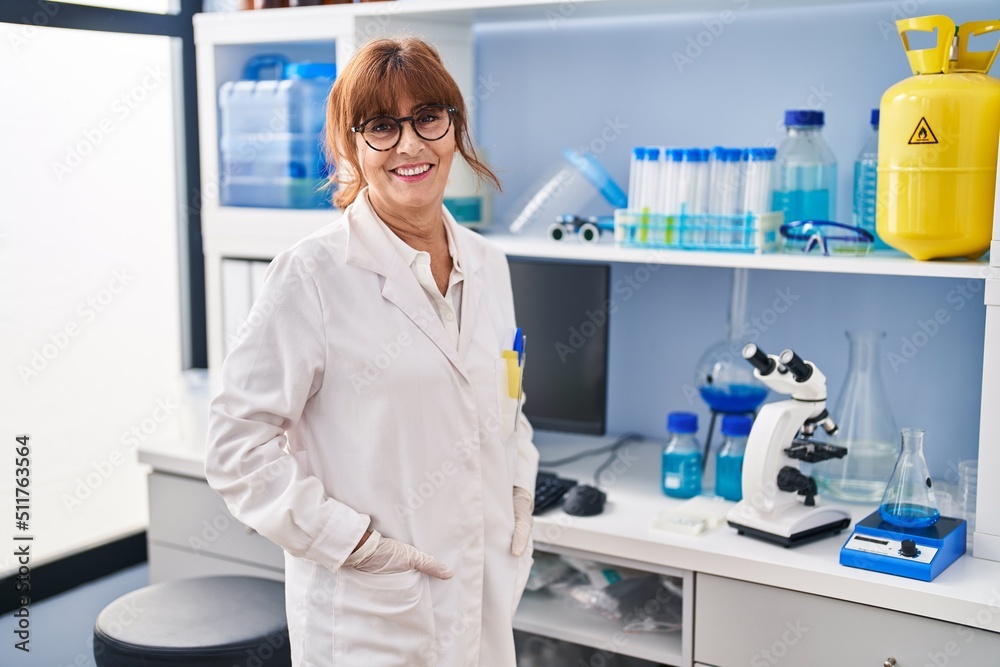 Middle age woman scientist smiling confident standing at laboratory Middle age woman scientist smiling confident standing at laboratory
