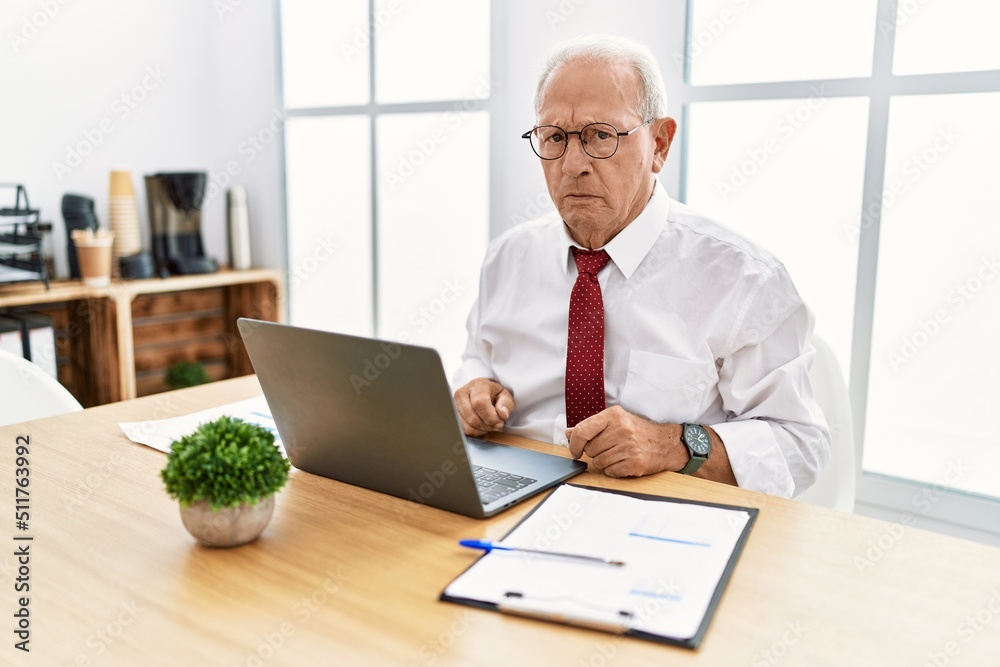 Senior man working at the office using computer laptop depressed and worry for distress, crying angry and afraid. sad expression. Senior man working at the office using computer laptop depressed and worry for distress, crying angry and afraid. sad expression.