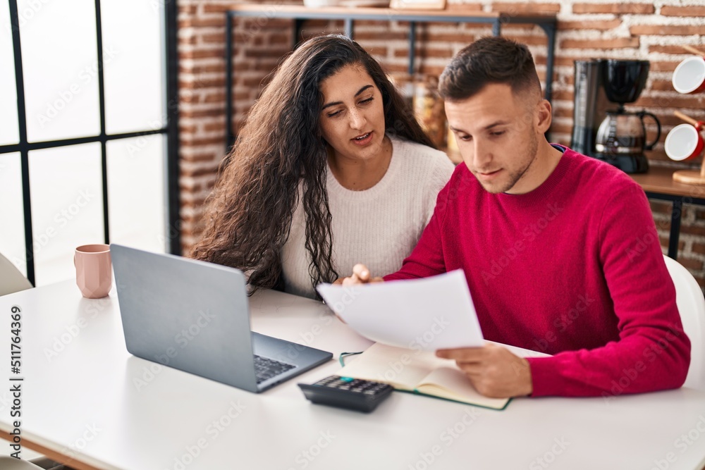 Man and woman couple calculating family economy at home Man and woman couple calculating family economy at home