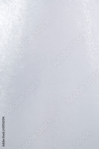 Close-up of uneven backlit glass surface with abstract lines and patterns. Copy space. High resolution full frame abstract background.