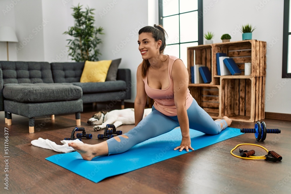 Young woman smiling confident stretching at home Young woman smiling confident stretching at home