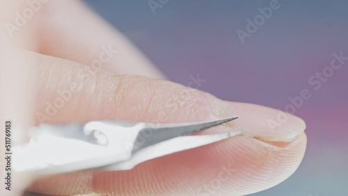 Macro of caucasian male finger with hangnails and the scissors.