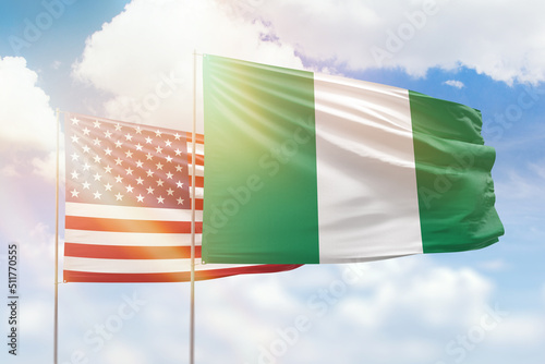 Sunny blue sky and flags of nigeria and usa photo