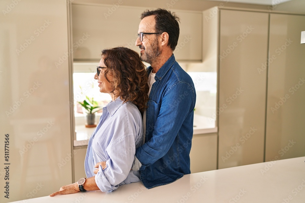 Middle age couple standing together looking to side, relax profile pose with natural face and confident smile. Middle age couple standing together looking to side, relax profile pose with natural face and confident smile.