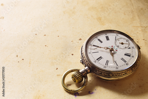 Vintage silver antique clock on old paper