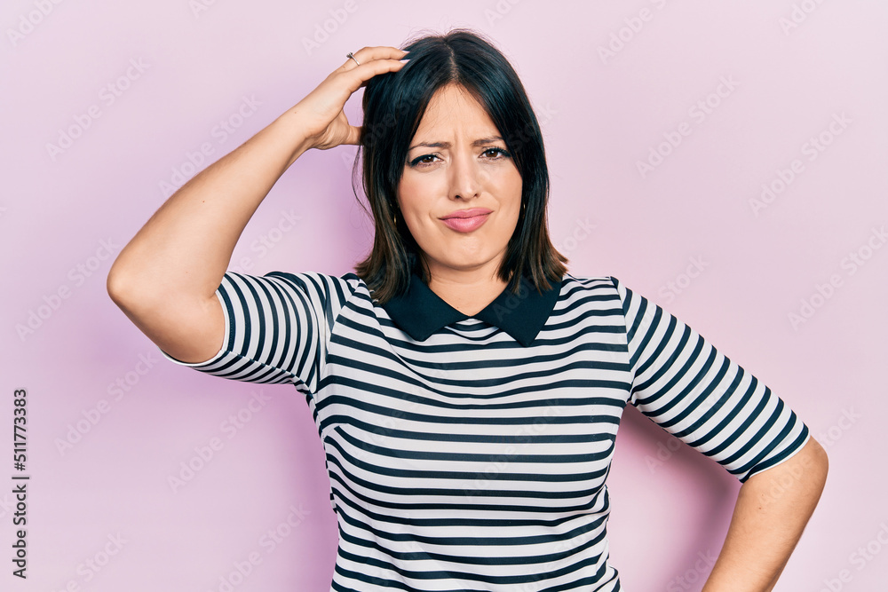 Young hispanic woman wearing casual clothes confuse and wonder about question. uncertain with doubt, thinking with hand on head. pensive concept. Young hispanic woman wearing casual clothes confuse and wonder about question. uncertain with doubt, thinking with hand on head. pensive concept.