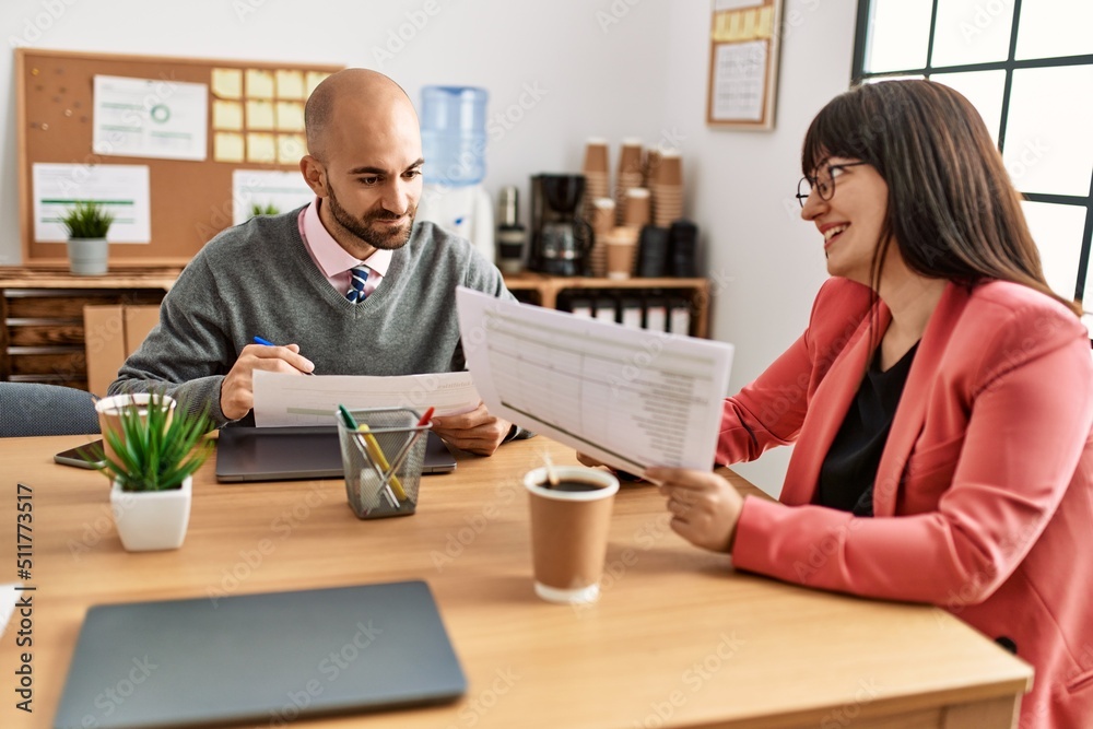 Two hispanic business workers smiling happy working at the office. Two hispanic business workers smiling happy working at the office.