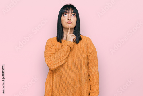Young hispanic woman wearing casual clothes thinking concentrated about doubt with finger on chin and looking up wondering © Krakenimages.com